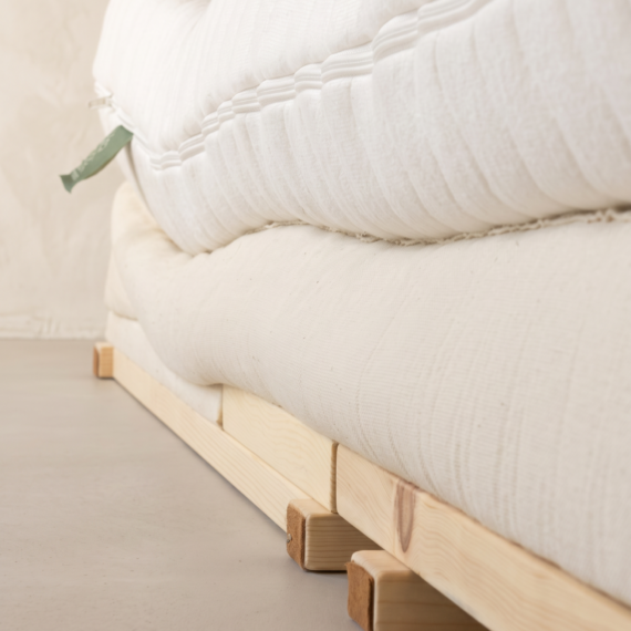 Detail Schlafsystem PINURA: Naturmatratze und Unterbett auf Zirbenholzrahmen, Seitenansicht – Schlafmanufaktur